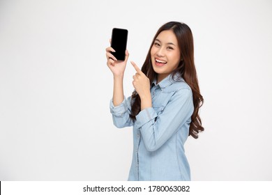 Portrait of Asian woman showing or presenting mobile phone application and pointing finger to smartphone on hand isolated over white background, Asian Thai model