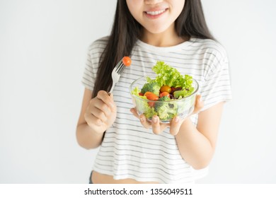 Portrait Of Asian Woman Smiling And Eating Salad On White Background At Home, Food For Health Care And Diet