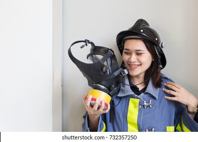 The Portrait Of Asian Woman Smiling And Wearing Fire Fighter Suit.