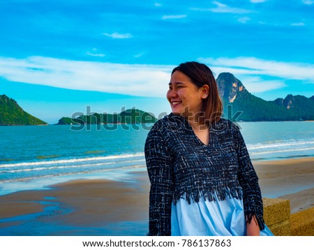 Portrait of Asian woman , Thai girl at Prachuap Khiri Khan beach with Khao Lom Muak background