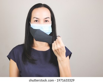 Portrait Of Asian Woman Wearing  Double Face Masks  Or Two Face Masks For Better Protection  From Coronavirus Or Covid-19 Outbreak - Concept Of Safety, Healthcare, Medical And Hygiene.