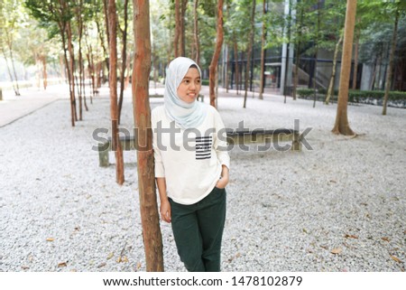 Portrait of an asian woman wearing hijab and smart casual attire