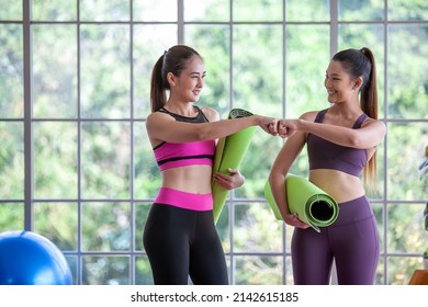 Portrait Of Asian Woman Wearing Sportswear Holding A Yoga Or Fitness Mat, Hi Five And Smile.