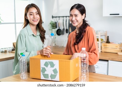 Portrait Of Asian Women Hold Trash Bin For Further Recycling At Home. Attractive Female Put Plastic Bottles Into Recycle Box For Ecologically Friendly And Saving The Environment. Zero Waste Concept.