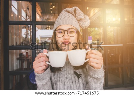 Portrait of asian women holding a couple cup of coffee.