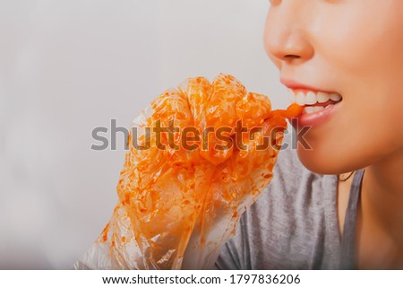 Portrait Asian women use their mouth to taste carrots through seasoning, fermentation, pickles, kimchi making, eating that taste delicious.
