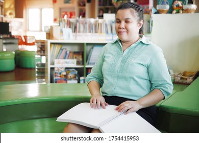 Portrait Of Asian Young Blind Person Woman Disabled People Reading Braille Book In Creative Workplace