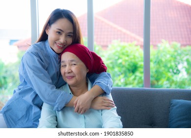 Portrait of Asian young daughter embrace and smile very happily with her elderly mother who survive from cancer. Cancer or leukemia survivor concept. - Shutterstock ID 1901835850