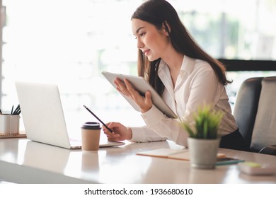 Portrait Of Asian Young Female Working On Laptop 