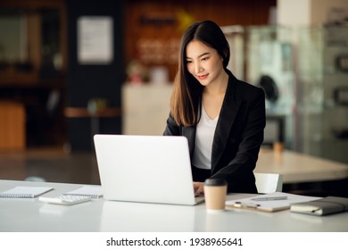 Portrait Of Asian Young Female Working On Laptop At Office