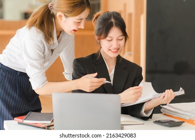 Portrait Of Asian Young Female Working On Laptop At Office