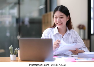 Portrait Of Asian Young Female Working On Laptop At Office