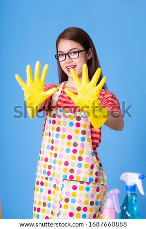 Portrait asian young housekeeper wearing yellow rubber gloves