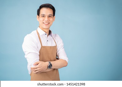 Portrait Of Asian Young Male Smiling At Light Blue Background.