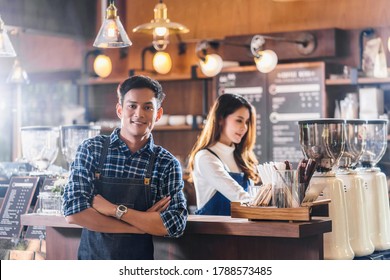 Portrait Of Asian Young Small Business Owner With Coffee Shop In Front Of Counter Bar, Entrepreneur And Startup,preparing For Service To Customer In Cafe Store And Restaurant,business Partner Concept
