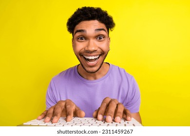 Portrait of astonished cheerful person beaming smile fingers typing keyboard isolated on yellow color background - Shutterstock ID 2311459267