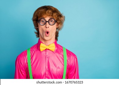Portrait of astonished guy look wonderful high school novelty impressed scream wow omg wear funny spectacles geek bright clothes isolated over blue color background
