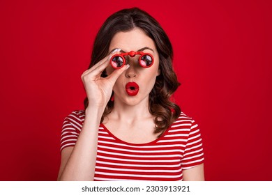 Portrait of astonished impressed lady wear stylish clothes have fun watching observing around isolated on red color background