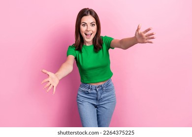 Portrait of astonished positive girl toothy smile raise opened arms welcome you isolated on pink color background