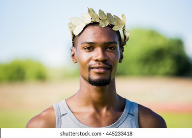 Portrait of athlete wearing green roman laurel wreath - Powered by Shutterstock