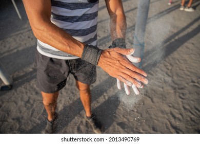 Portrait of an athlete's hands applying weightlifting Chalk Powder for training with weights - sportsman using equipment during training concept