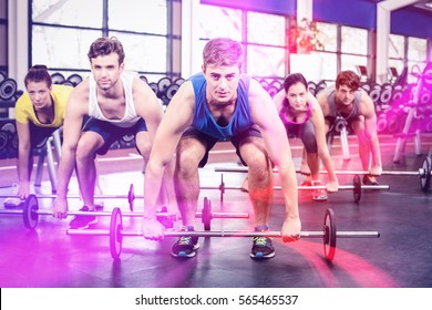 Portrait of athletic men and women working out at crossfit gym - Powered by Shutterstock