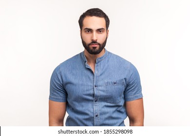 Portrait Of Attentive Self Confident Bearded Man Looking At Camera With Serious Expression, Unsmiling Determined Business Man. Indoor Studio Shot Isolated On White Background