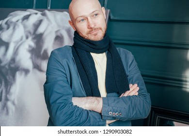 Portrait Of Attractive Adult Successful Bald Man Art Critic Historian With Beard In Scarf In Art Gallery