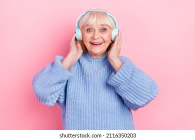 Portrait of attractive amazed cheerful grey-haired woman listening sound bass hit isolated over pink pastel color background - Powered by Shutterstock