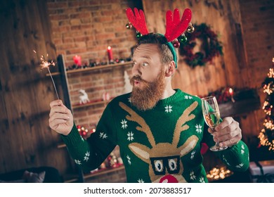 Portrait of attractive amazed funky guy drinking champagne holding bengal fire midnight at modern loft industrial style indoors - Powered by Shutterstock