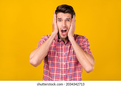 Portrait Of Attractive Amazed Worried Overwhelmed Guy Sudden News Reaction Isolated Over Bright Yellow Color Background