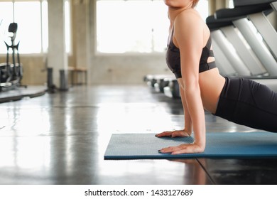 Portrait attractive asia woman athletes stretching at gym with blur running treadmill background - Shutterstock ID 1433127689