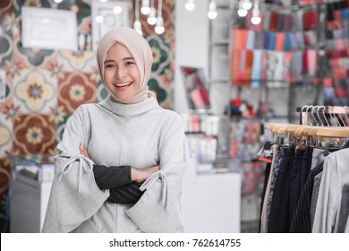 Portrait Of Attractive Asian Female Business Owner Standing Crossed Arm In Her Boutique Fashion Store. Muslim Entrepreneur Concept