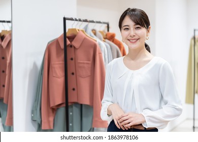 portrait of attractive asian woman in clothes store