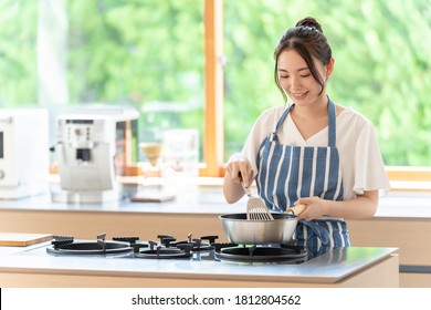 Portrait Of Attractive Asian Woman Cooking At Kitchen
