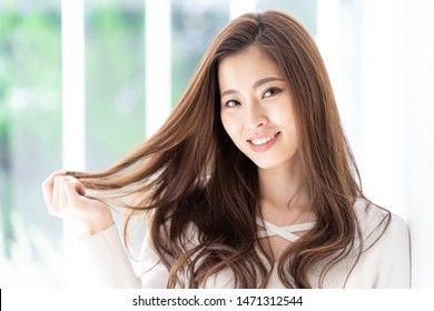 portrait of attractive asian woman hair care image