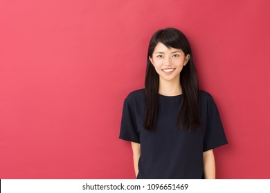 Portrait Of Attractive Asian Woman Isolated On Red Background