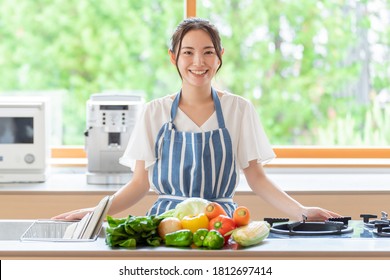 Portrait Of Attractive Asian Woman In Kitchen