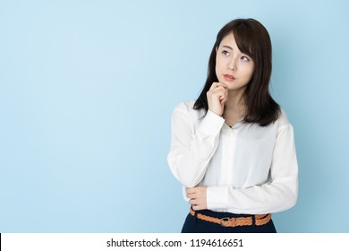 portrait of attractive asian woman on blue background