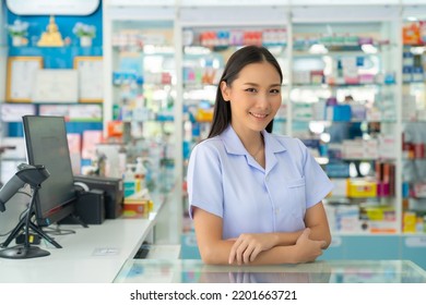 Portrait Of Attractive Asian Woman Professional Pharmacist Ready For Medication Advice About Medicine, Drugs And Supplements In Modern Drugstore. Medical Pharmacy And Healthcare Providers Concept.