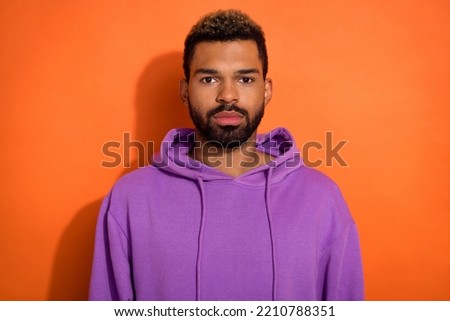 Portrait of attractive bearded man wear casual clothes purple pullover look camera isolated on orange color background