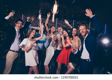 Portrait Of Attractive Beautiful Charming Glamorous Cheerful Ladies And Handsome Gentlemen With Wine Glasses, Chill Out At Night Club, Gathering, Raising Hands Up