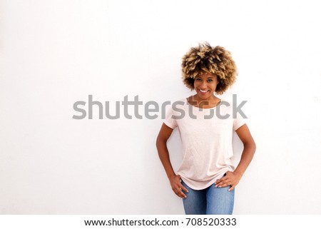 Similar – Young black woman, afro hairstyle, smiling near a wall in the street