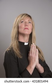 Portrait Of A Attractive Blond Female Clergy Wearing A Black Shirt And Dog Collar