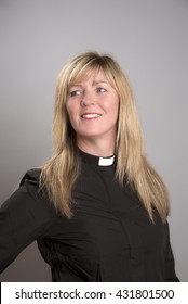 Portrait Of A Attractive Blond Female Clergy Wearing A Black Shirt And Dog Collar