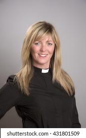 Portrait Of A Attractive Blond Female Clergy Wearing A Black Shirt And Dog Collar