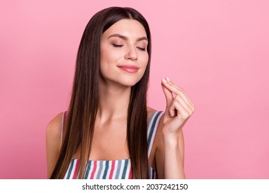 Portrait of attractive brown-haired dreamy cheerful girl tasting good food isolated over pink pastel color background