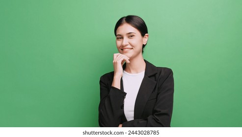 Portrait of attractive businesswoman in a suit. Isolated on green background in studio. - Powered by Shutterstock