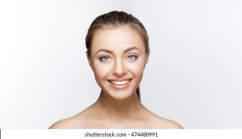 Portrait of attractive caucasian smiling woman brunette on gray background, studio shot toothy smile face long hair head and shoulders