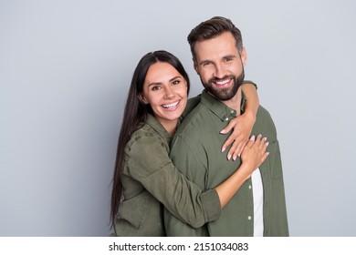 Portrait of attractive cheerful amorous couple best friends hugging romance spending time isolated over grey pastel color background